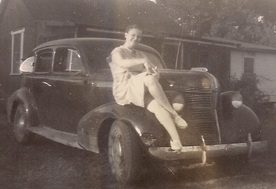 old picture of woman on car