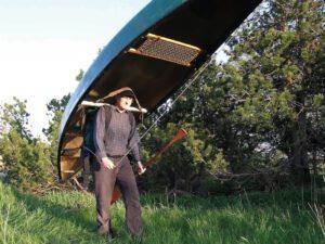 Use a tumpline to carry a canoe